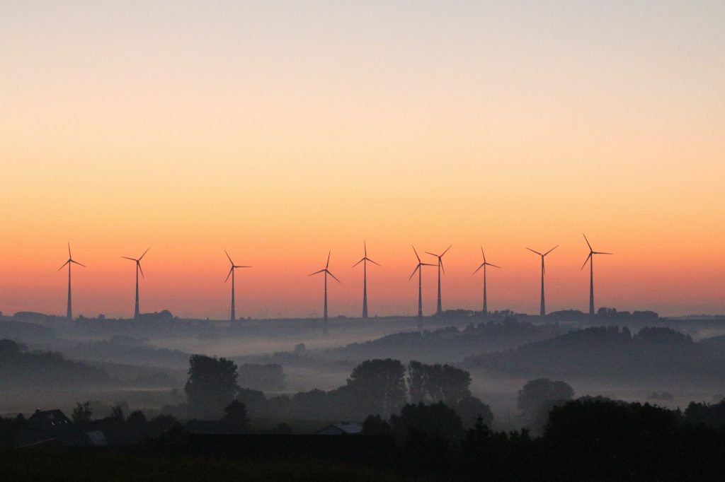 windmills for electricity generation at sunrise